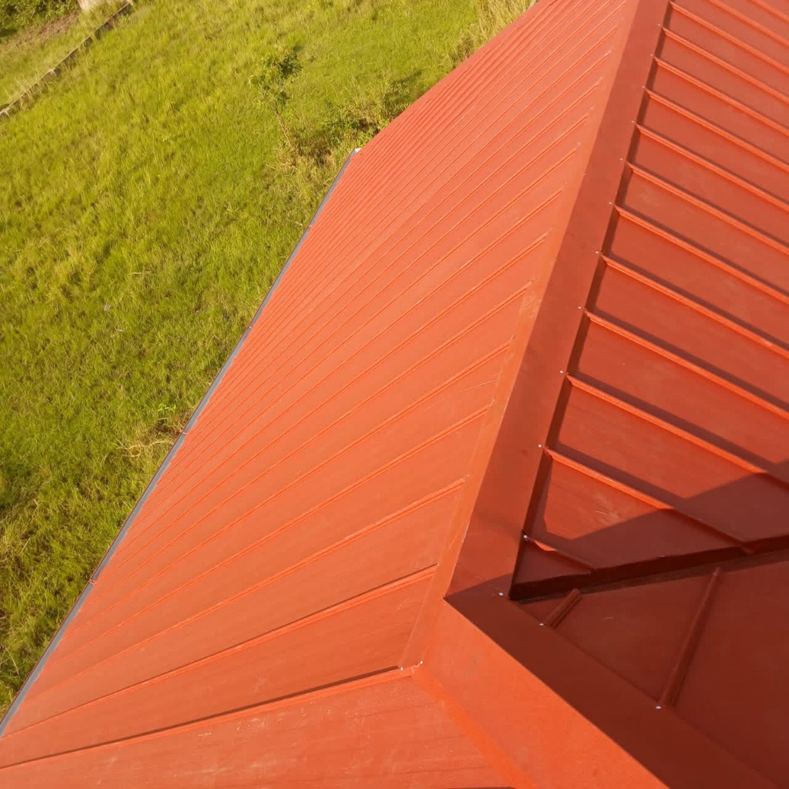 Close-up of red roofing panels and seams